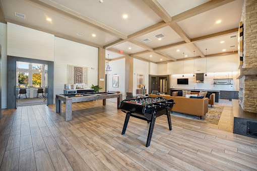 A room with a pool table and a couch.