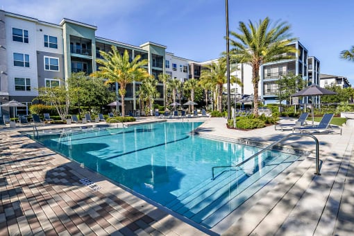 a swimming pool in front of an apartment building