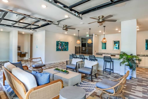 a living room with couches and chairs and a bar