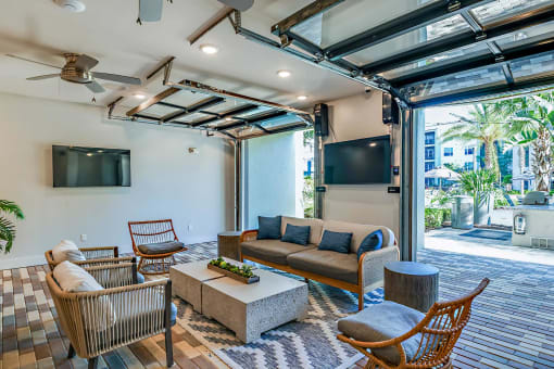 a living room with a couch and chairs and a tv