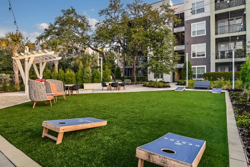 an apartment yard with a ping pong table and chairs