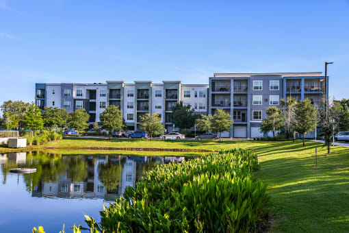 a large pond in front of an apartment building