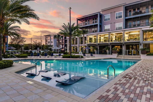 a large swimming pool in front of a building
