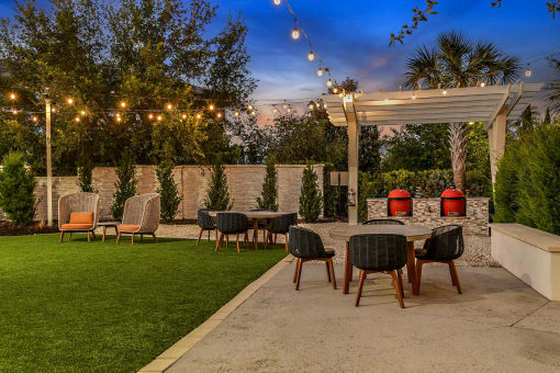 a patio with a table and chairs under a canopy