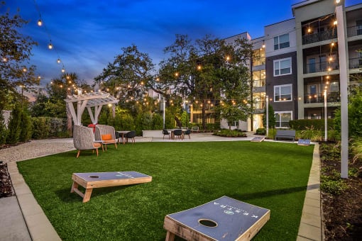 a backyard with a grass lawn and a fire pit