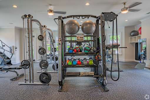 A home gym with a variety of equipment including weights and resistance bands.