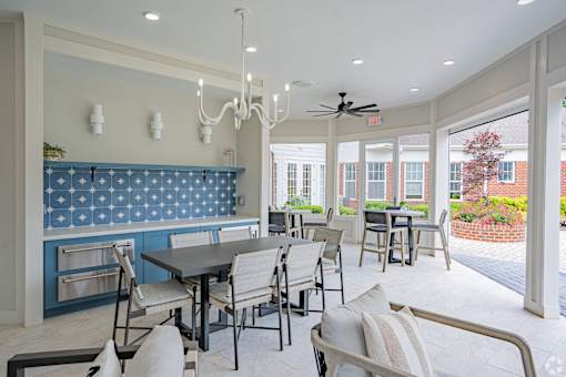 A dining room with a table and chairs.