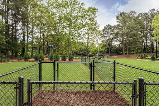 A black fence surrounds a baseball diamond.