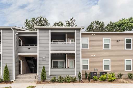 A modern two-story apartment building with a garage on the first floor.