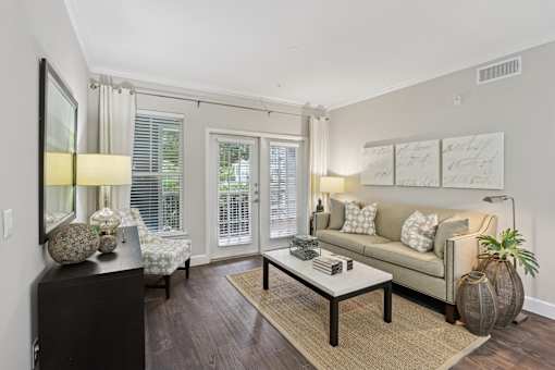 A living room with a couch, a coffee table, and a side table with a lamp.