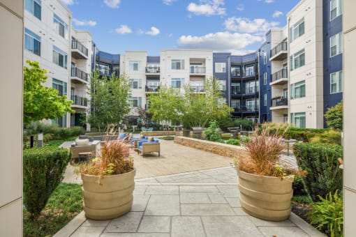 an outdoor patio with potted plants at the bradley braddock road station apartments