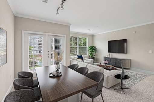 A modern dining room with a wooden table and grey chairs.