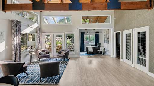 A living room with a couch, chairs, and a table.