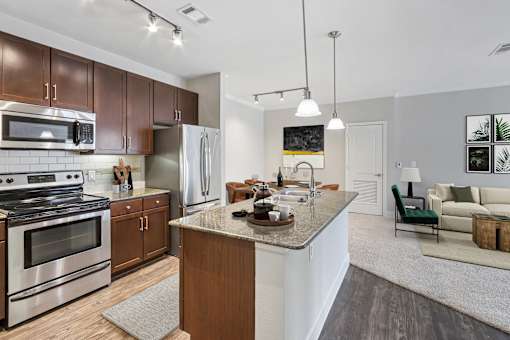 A modern kitchen with a stainless steel stove and refrigerator.