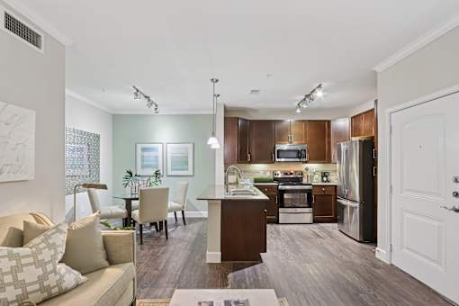 A modern kitchen with dark wood cabinets and stainless steel appliances.
