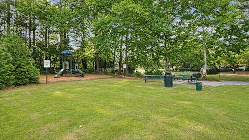 A park with a gazebo, benches, and trees.