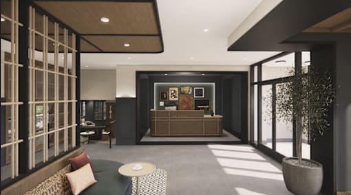 A modern living room with a dark grey sofa and a wooden coffee table.