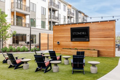 a group of tables and chairs in front of a wooden building at Stonehill at West Orange, West Orange, NJ, 07052