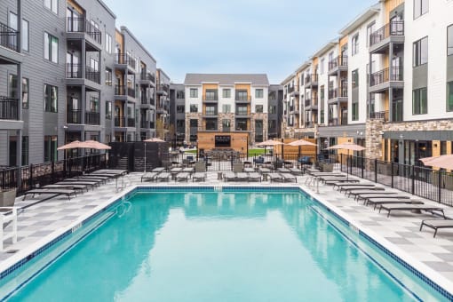 a swimming pool in the middle of an apartment building at Stonehill at West Orange, West Orange, New Jersey