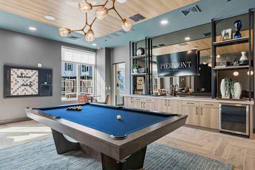 Clubhouse game room with pool table and bar at The Piermont Apartments, Hillsdale, 07642