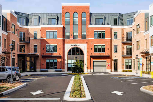 Brick building facade with arched entrance at The Piermont Apartments, New Jersey, 07642