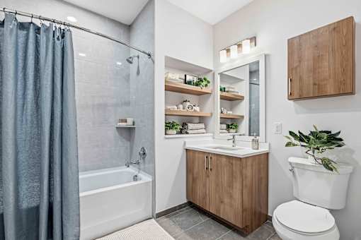 Bathroom with wood vanity and walk in tub at The Piermont Apartments, New Jersey