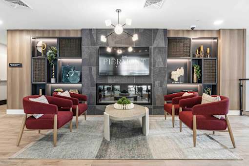 Lounge area with fireplace and built in shelving at The Piermont Apartments, Hillsdale, NJ 07642