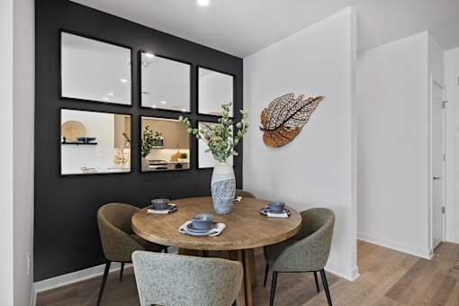 A dining room with a round table and chairs at The Reserve at Pearl River Apartments, Pearl River, NY, 10965