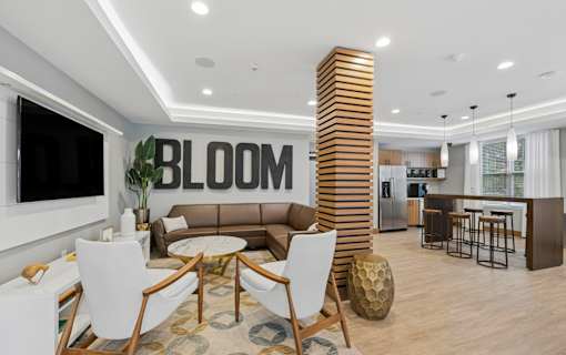 A modern living room with a large sofa, a coffee table, and a tall wooden column.