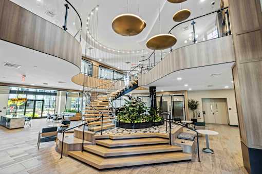 Grand entrance lobby with floating wooden staircase at The Piermont Apartments, New Jersey, 07642