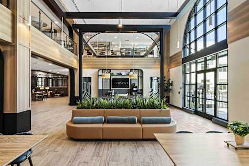 Two story lobby with planter seating and mezzanine at The Piermont Apartments, Hillsdale, NJ 07642