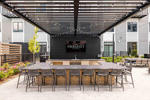 Outdoor courtyard bar with covered pergola seating at The Piermont Apartments, New Jersey