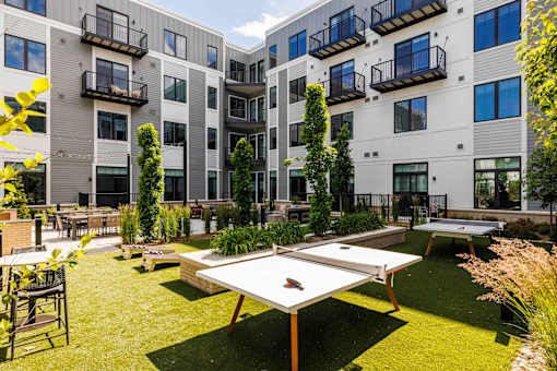 Courtyard with ping pong tables and landscaped greenspace at The Piermont Apartments, New Jersey, 07642