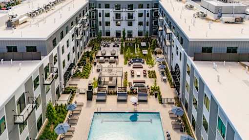 Rooftop courtyard with pool and lounge seating at The Piermont Apartments, Hillsdale, NJ