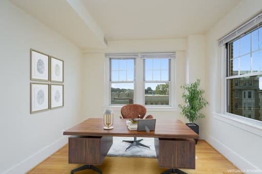 a home office with two windows and a wooden desk at 1841 Columbia Road Apartments, Washington, 20009
