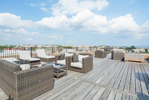a rooftop deck with lounge chairs and a fire pit at 1841 Columbia Road Apartments, Washington, Washington DC