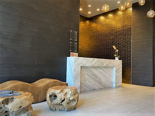 apartment lobby with black walls and a white marble reception desk at Tribeca, District of Columbia