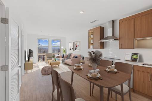 A modern kitchen with a dining table set for two.