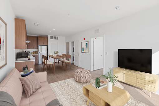 A living room with a pink couch and a wooden coffee table.