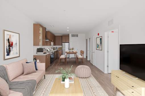 A living room with a couch, a coffee table, and a television.