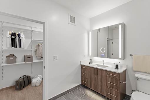 A bathroom with a white sink and a mirror above it.