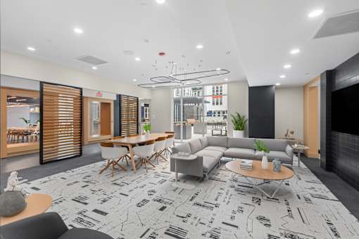A modern living room with a patterned carpet and a variety of seating options.