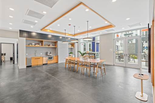 A modern open space with a kitchen, dining area, and a bar.