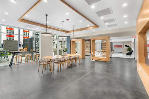 A modern dining area with a long table and chairs.