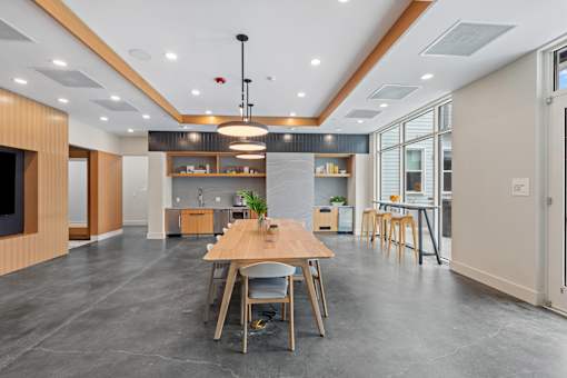 A modern kitchen with a dining table and chairs.