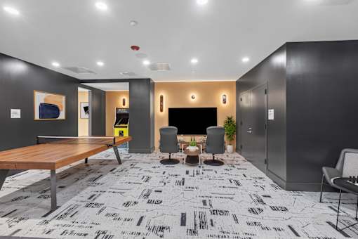 A modern office space with a patterned carpet and a wooden table.