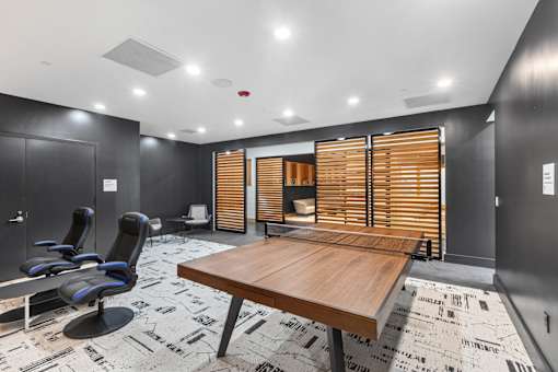 A conference room with a long table and chairs.