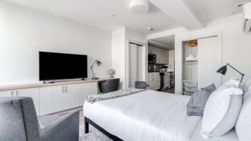 a bedroom with a large bed and a flat screen tv