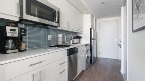 a kitchen with a stove top oven next to a refrigerator