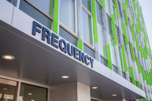 a building with a sign that says frequency
